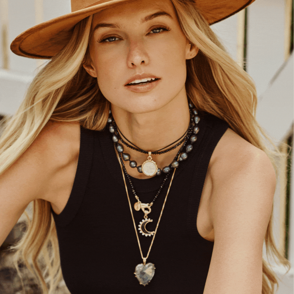 Model wearing Jane Win coin pendants and the full heart pendant that Jenna Bush wears