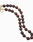 Wood beaded necklace with gold accents and oversized gold lobster clasp