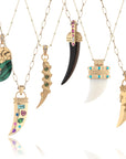 Various tusk pendants on different chains