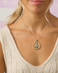 Model wearing the give peace a chance pendant on the classic rolo chain
