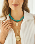 Model wearing various lucky pendants and the stone collector beaded necklace in turquoise