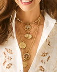 Model wearing various pendants from the faith collection on a variety of chains