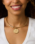 Model wearing the embellished neck cuff with the gratitude coin