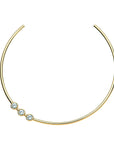 Gold neck cuff features three bezel set white CZ stones that sit off center