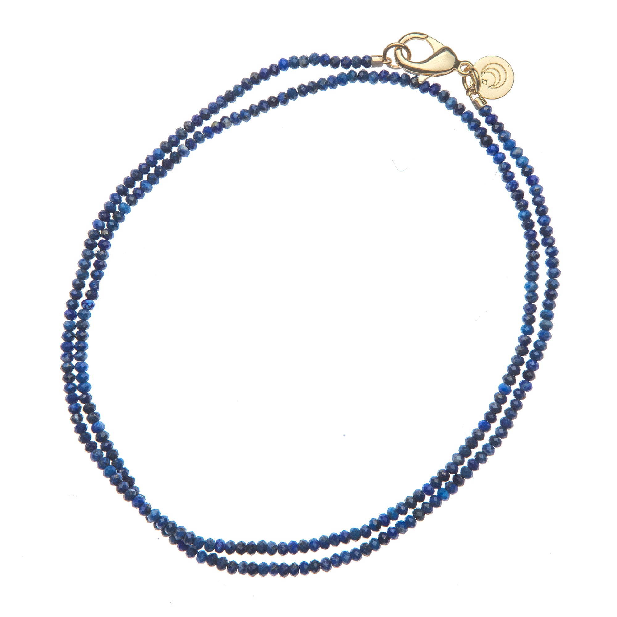 Beaded necklace of lapis beads with oversized gold clasp