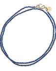 Beaded necklace of lapis beads with oversized gold clasp