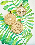 Stylized shot of gold coins with watercolor leaves