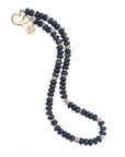Obsidian beaded necklace with gold bead accents and oversized gold