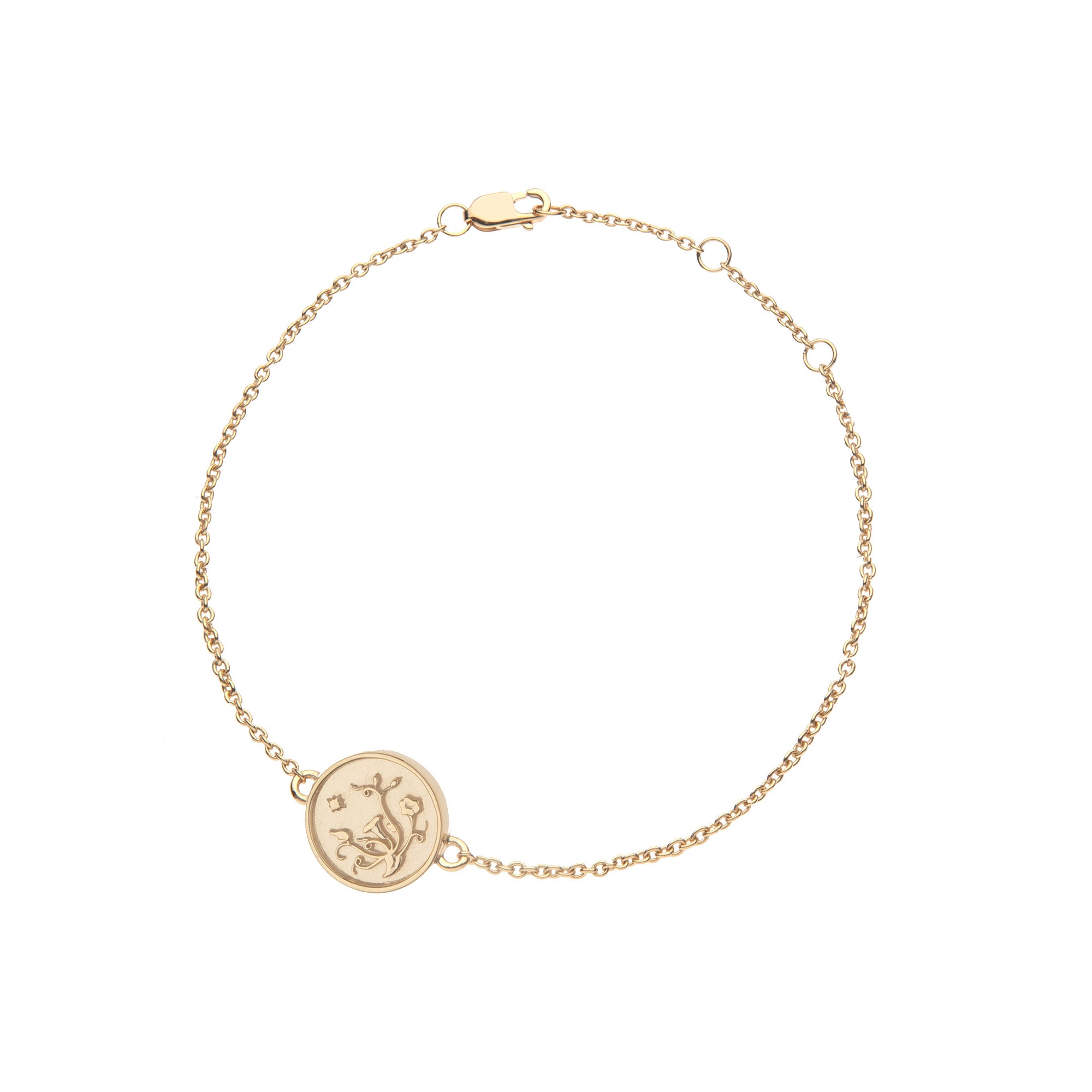 Delicate gold bracelet featuring tiny coin with morning glory design