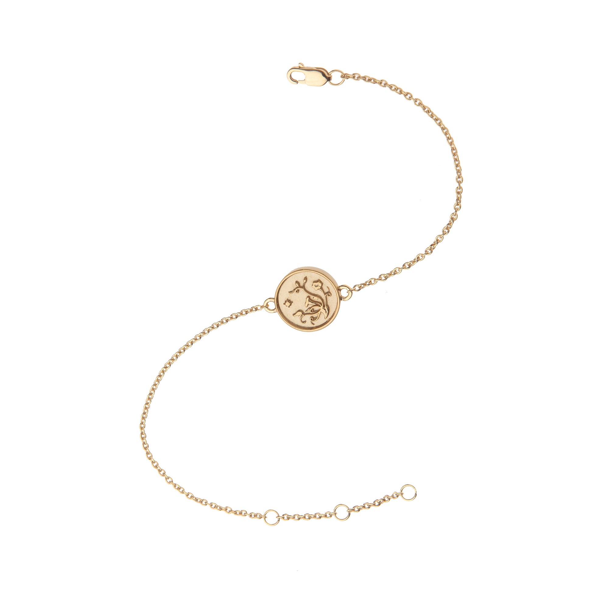 Delicate gold bracelet featuring tiny coin with morning glory design