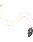 Carved onyx feather pendant on 18 inch 14 karat satellite chain