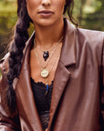 Model wearing layered fox pendants