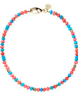 Beaded necklace with mix of turquoise and coral beads with flat gold beads interspersed. Necklace features oversized gold lobster clasp