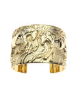 Gold cuff bracelet featuring two horses