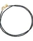 Black agate beaded necklace with oversized gold lobster clasp shown double wrapped