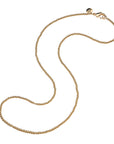 Gold beaded necklace with oversized lobster clasp