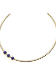 Gold neck cuff with three lapis cabochons sitting off center
