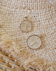 Small and Original Size Gold Faith coins styled on a woven surface