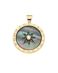 Gold and black mother of pearl coin pendant with carved sundial design, white mother of pear; center accent, and roman numeral border