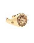 Side view of gold sundial signet ring shows star detail on the side