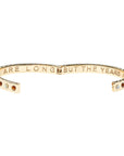Hinged cuff shown open to show the inscribed phrase "the days are long but the years are short"