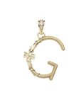 Gold letter G pendant with flower detail and white topaz accents on the bail