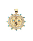 Gold coin pendant featuring and owl face with embellished stone details of London Blue Topaz, White Topaz, Blue Sapphire, and Smoky Topaz
