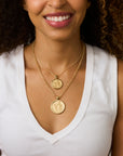 Model wearing the gratitude original coin on the grande rolo chain and the gratitude small coin on the classic rolo chain