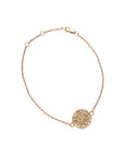 Gold chain bracelet with small gold coin with design of four quadrants of flowers