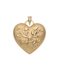 Gold heart pendant with flower design and star detail with white topaz detail on bail