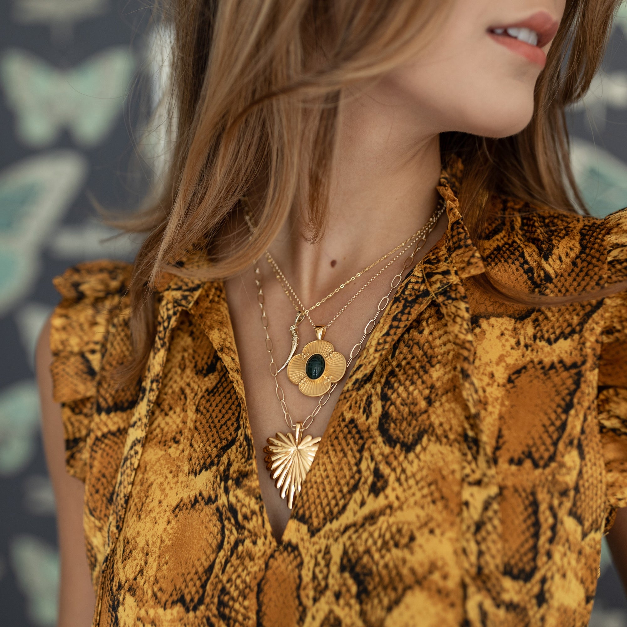 Gold necklaces layered on model