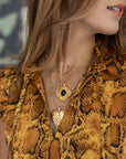 Gold necklaces layered on model