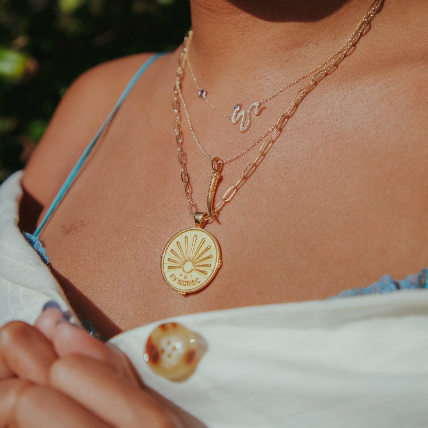Gold necklaces layered on model