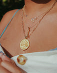 Gold necklaces layered on model