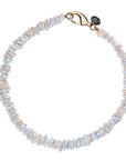 Beaded necklace of mother of pearl discs with oversized gold lobster clasp