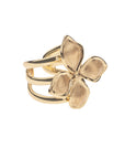 Gold ring features dogwood flower