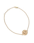 Gold chain bracelet with small love coin featuring moon and star logo and the word LOVE on the back