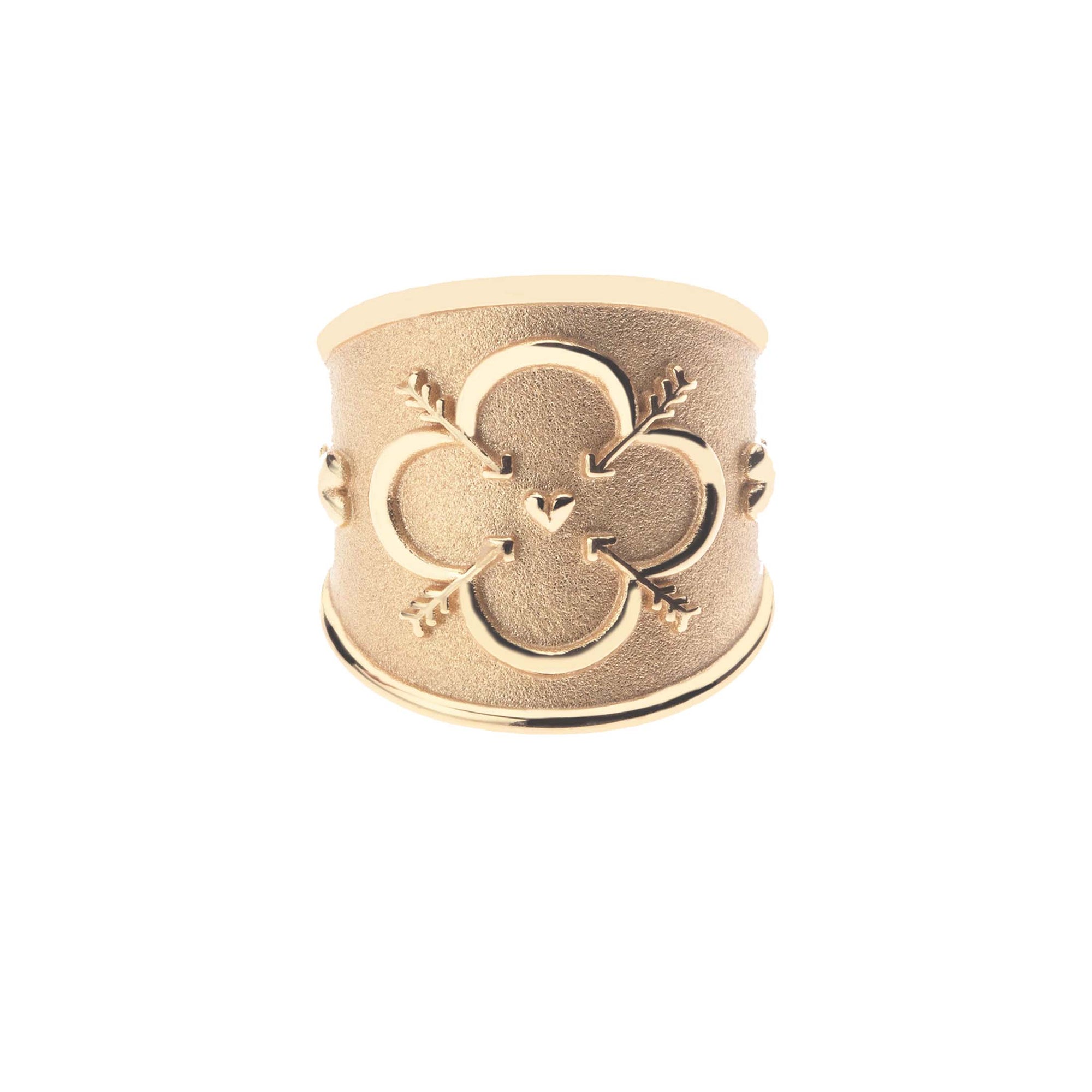 Gold cigar band ring with quatrefoil design featuring arrows and a heart