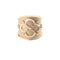 Gold cigar band ring with quatrefoil design featuring arrows and a heart
