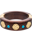 Carved wooden bangle featuring 2 turquoise stones and 3 small love coin designs