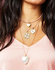 Model wearing gold layered necklaces