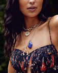 Model wearing gold pave wishbone