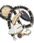 Pile of feather pendants and black beaded chain