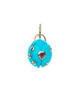 Carved turquoise ladybug with rainbow of stones and pink tourmaline heart in the center, set in gold
