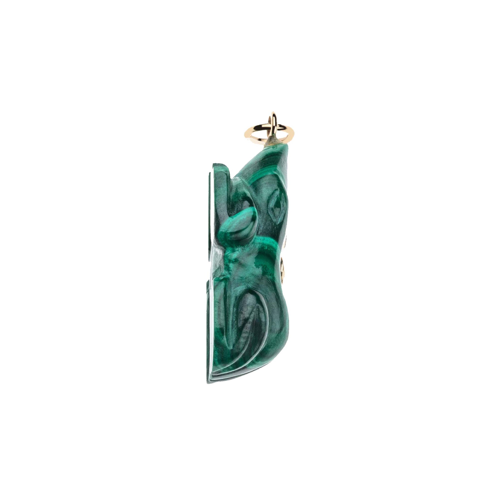 Side view of carved malachite frog