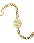 Chunky link gold bracelet features double sided coin with the words BONNE CHANCE on one side