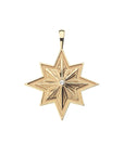 Gold 8 point star pendant with white topaz center stone