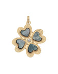 Four leaf clover pendant features heart shaped black mother of pearl stones on each leaf, as well as white topaz center stone