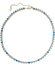 Gold tennis necklace features heart shaped CZ stones in varying shades of blue