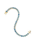 Gold tennis bracelet features heart shaped CZ stones in varying shades of blue